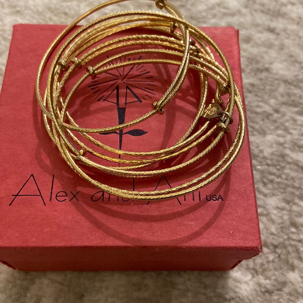 7 adjustable gold Alex and Ani bracelets